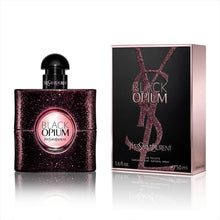 Load image into Gallery viewer, Black Opium Perfume by Yves Saint Laurent, Black Opium is an Oriental vanilla women’s fragrance with vanilla, coffee, and sweet main accords. Launched in 2014, this scent was a collaboration between perfumers Nathalie Lorson, Marie Salamagne, Olivier Cresp, and Honorine Blanc.  Notes: It is housed in a dark bottle with sequin decorations to present a glam rock look. Pear, pink pepper, and orange blossom